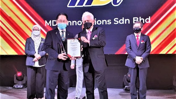 CEO of MDTi, Liew Choon Lian accepts Digitalization Advocate award from MATRADE CEO, Mohd Mustafa Abdul Aziz.